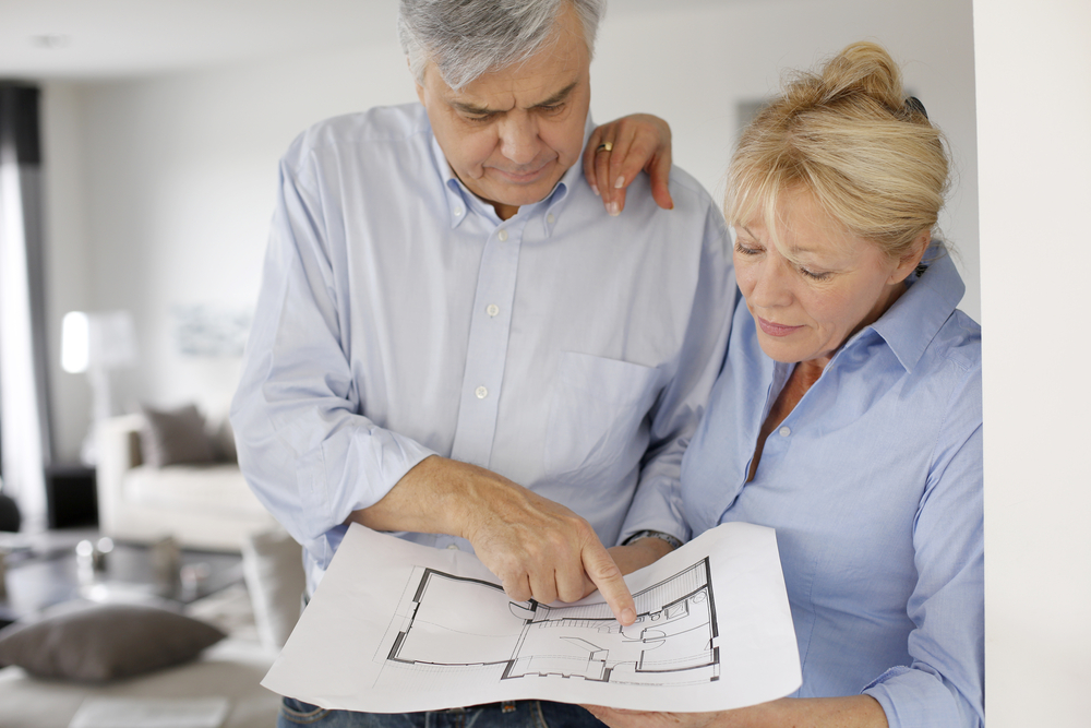 older couple looking at floor plans, home renovation, aging-in-place