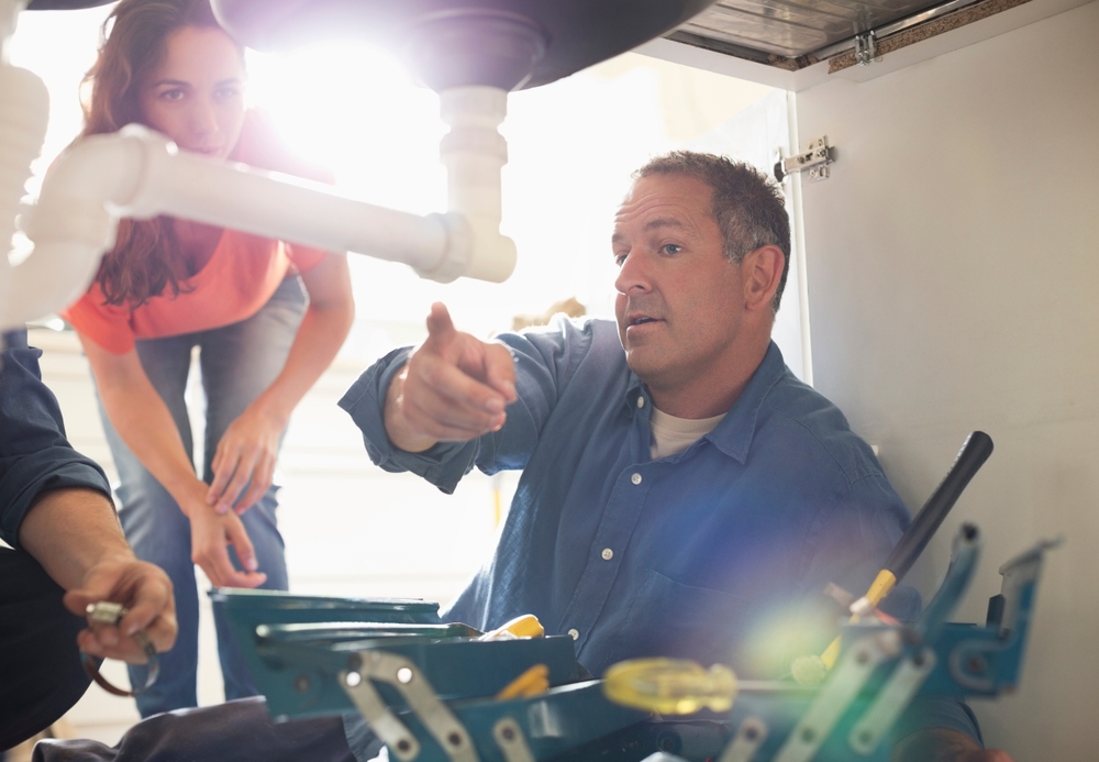 plumber explaining repair to home owner