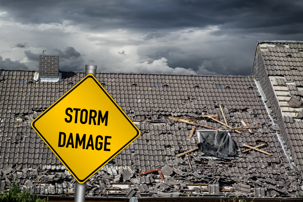 storm damage sign, damaged roof, stormy skies